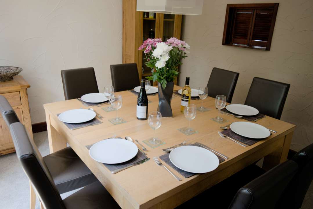 Dining room with table set for 8 people